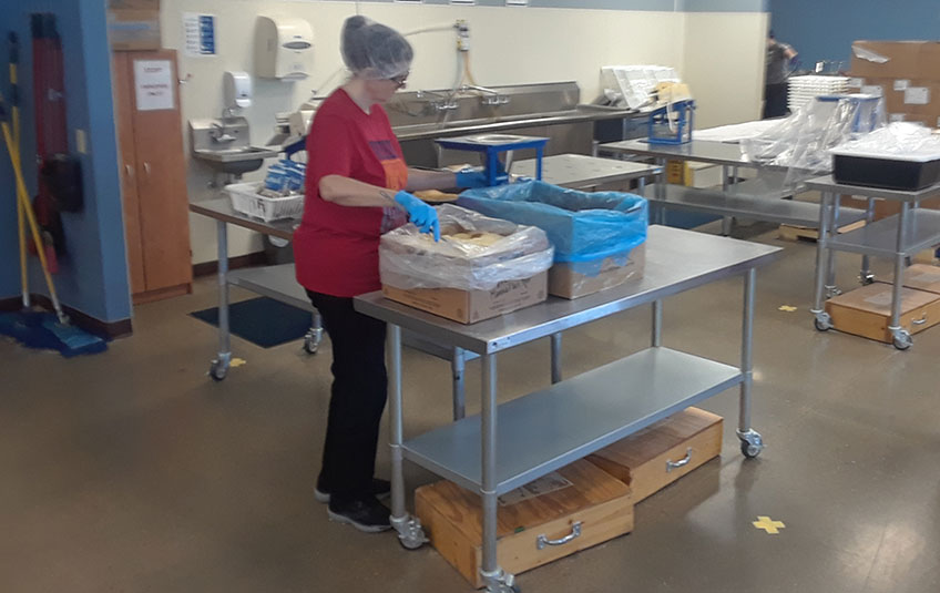 jennifer moulton standing by FMSC ingredient boxes