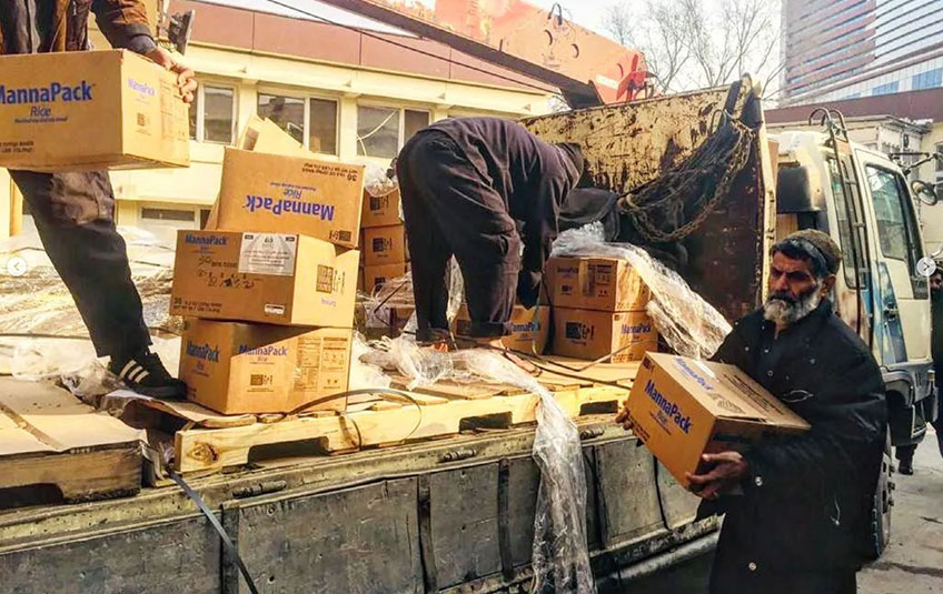 FMSC meals are unloaded from a truck in Afghanistan