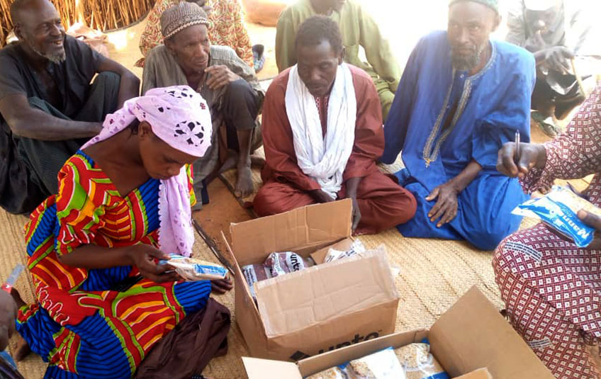 A circle of adults around FMSC food boxes