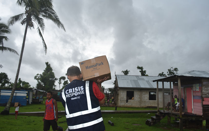 a man carrying a box of FMSC food