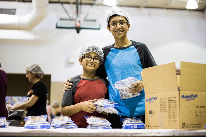 Two volunteers packing FMSC food