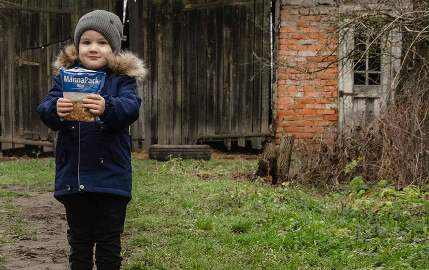 Ukrainian boy holding FMSC food