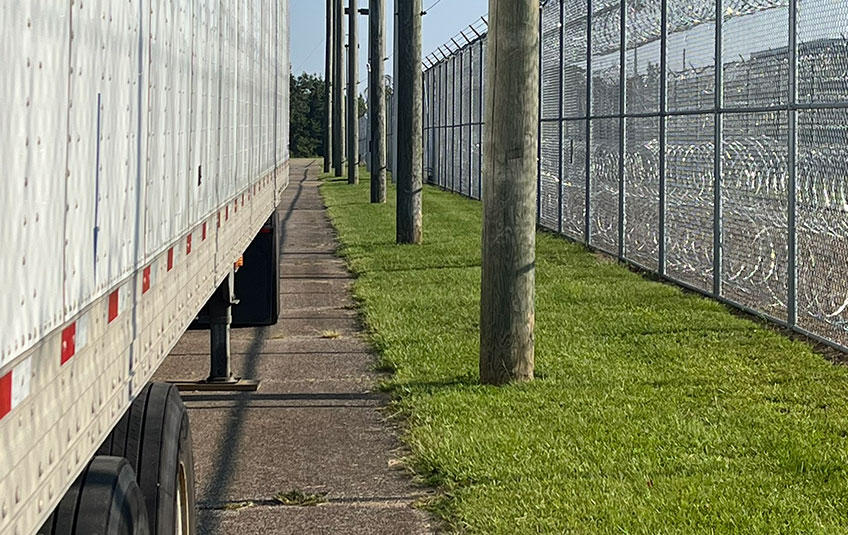 Semi-trailer parked alongside security fence at Marshall County Correctional Facility