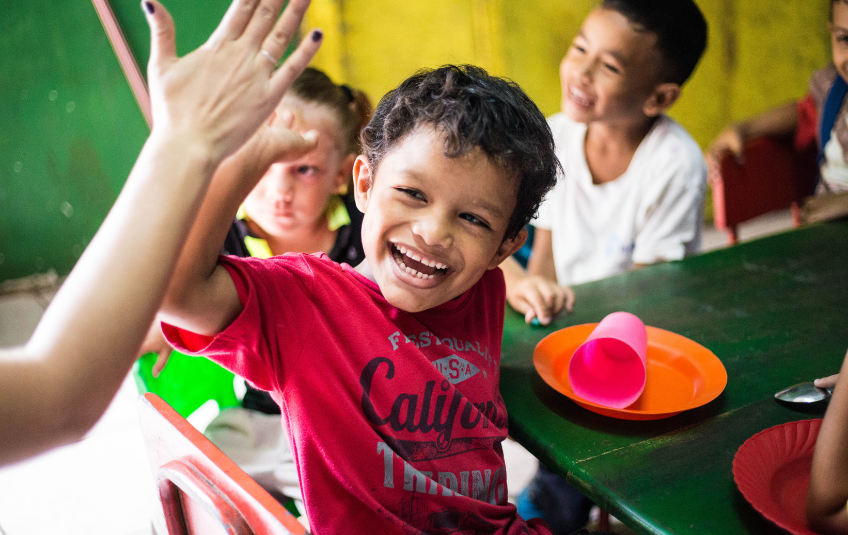 Child giving a volunteer a high five 