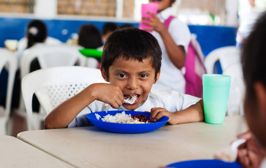 Young boy eating FMSC meal