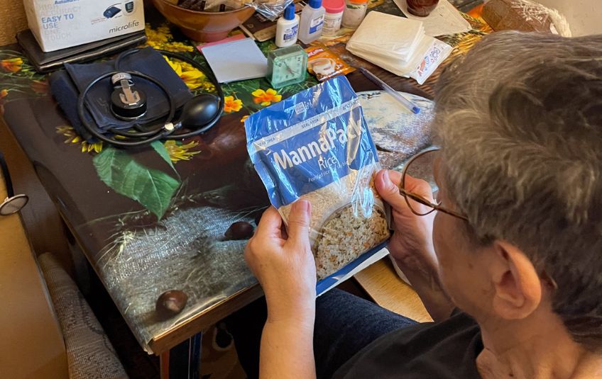 Tetiana looking at a bag of MannaPack. 