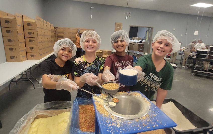 Four middle school boys volunteering at FMSC. 