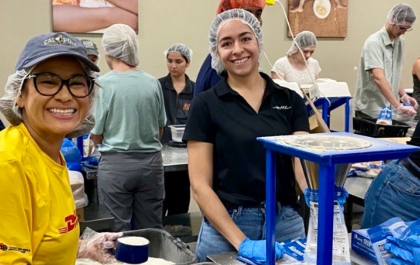 2 women in hairnets volunteering at fmsc