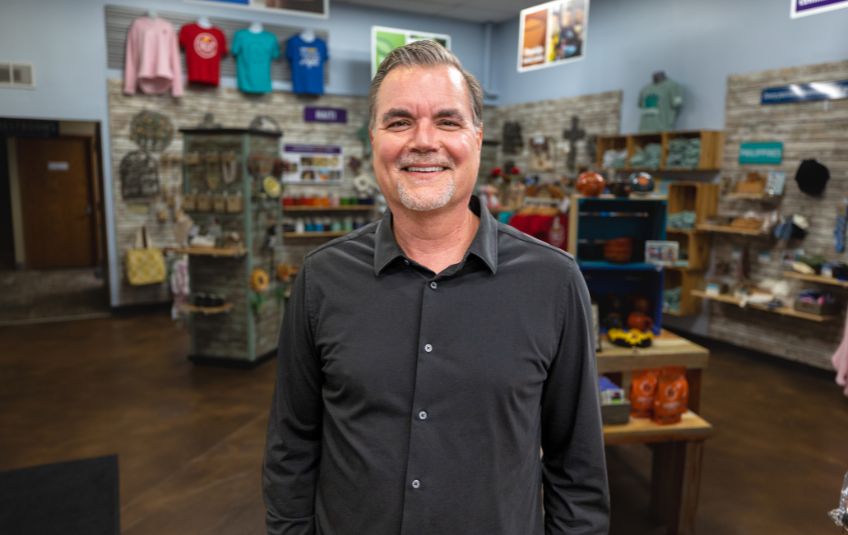 headshot of Christian nonprofit organization FMSC CEO J.J. Slag in front of FMSC MarketPlace store
