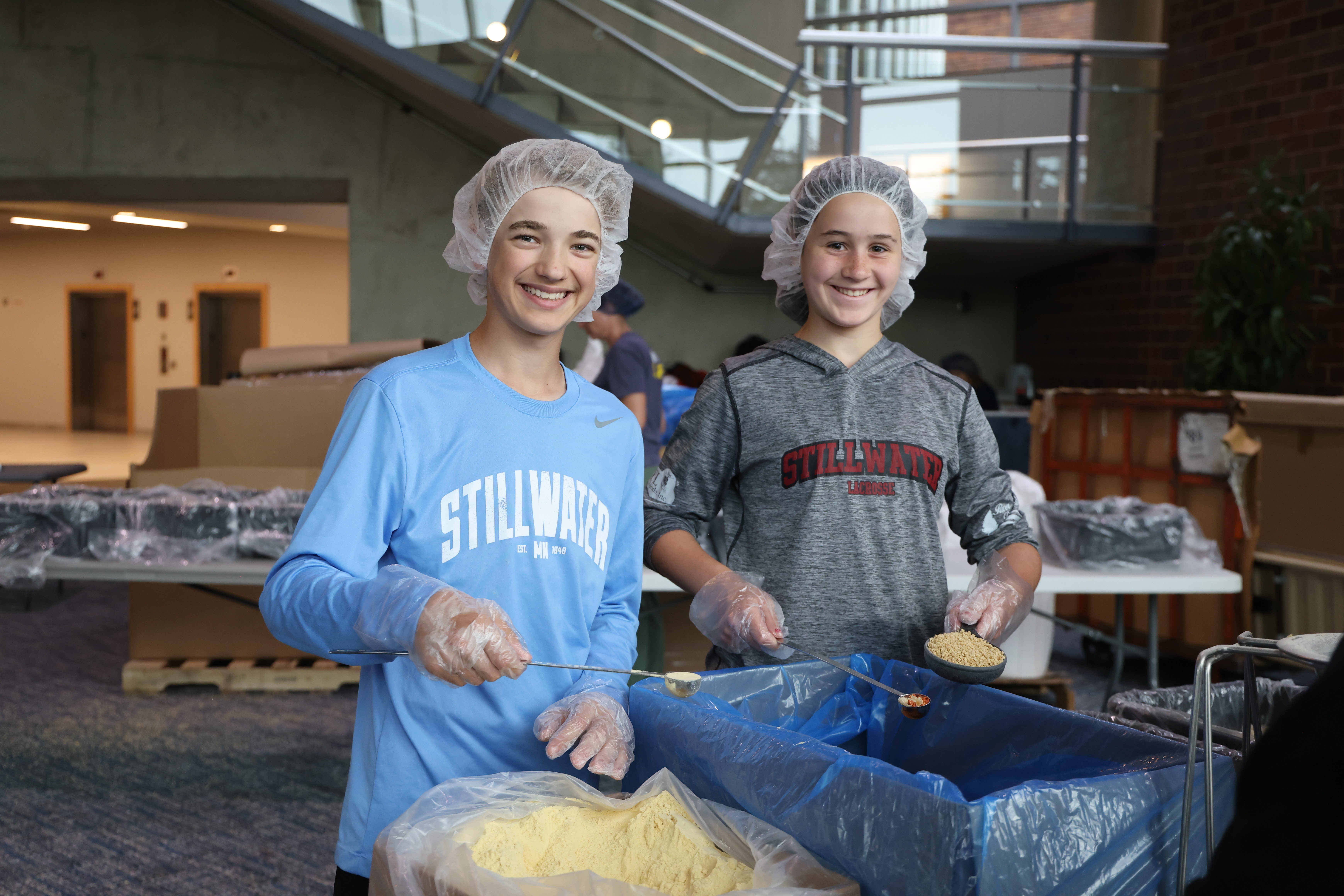 teen volunteering opportunity, wearing hairnets and scooping food