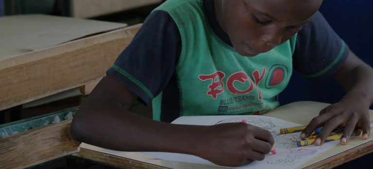 A girl coloring at a desk
