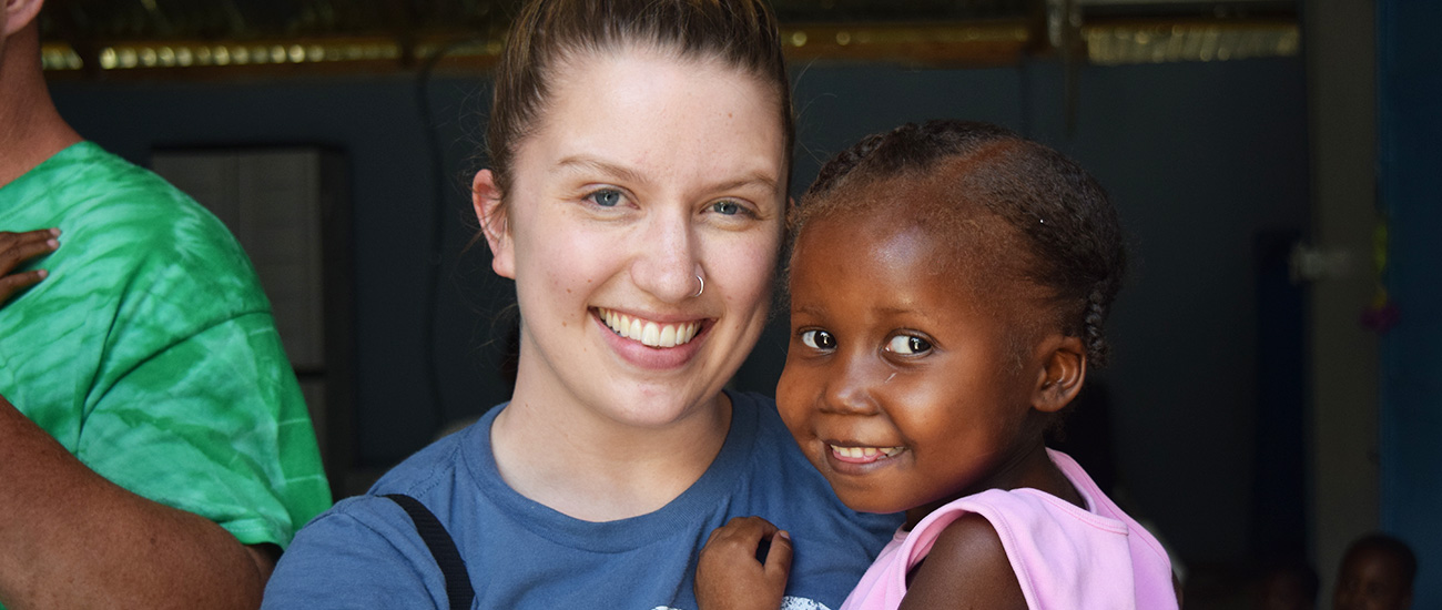 Lianna Cotant with a child in Haiti